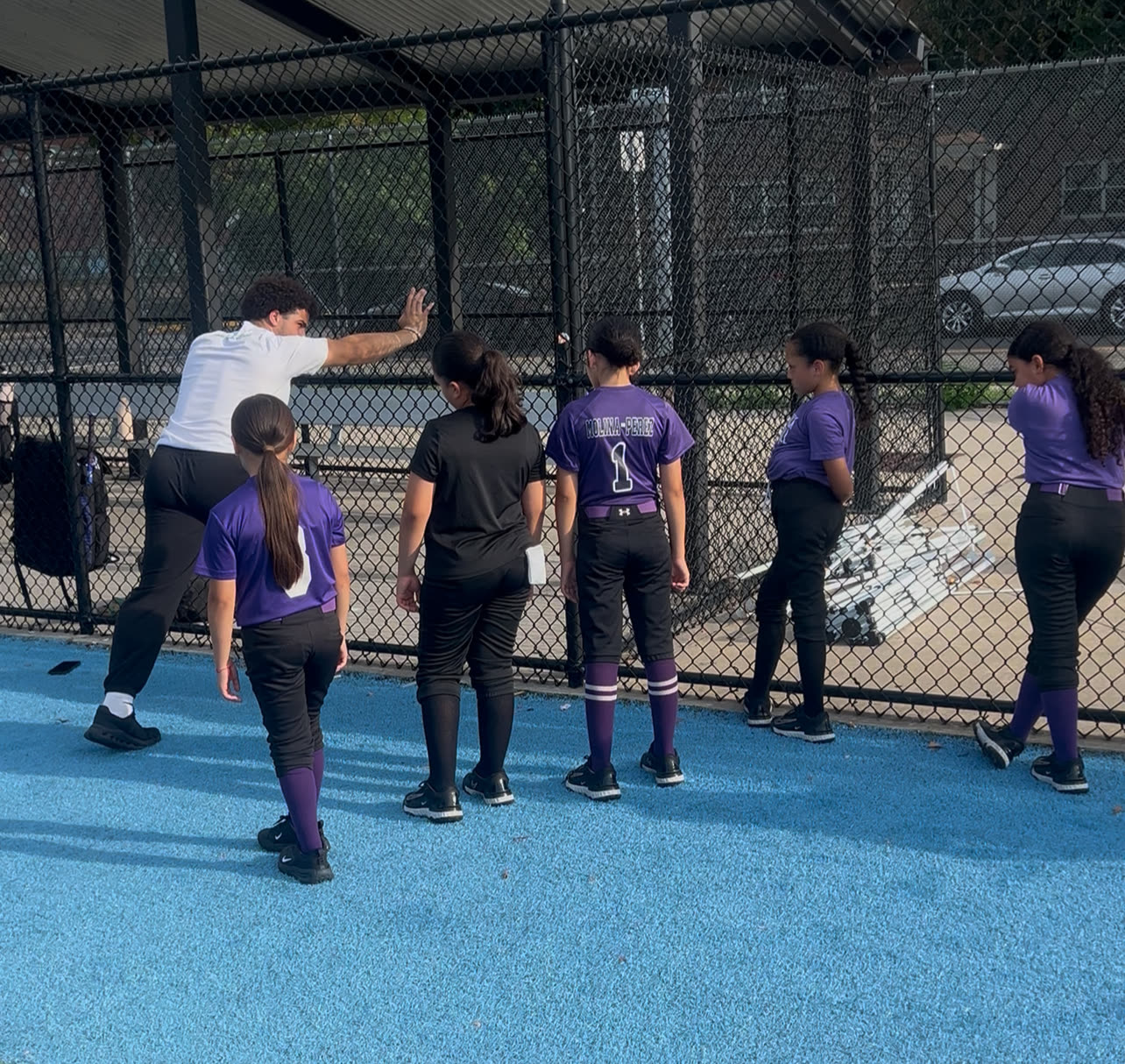 A Plus2 coach giving an athlete detailed instruction during training
